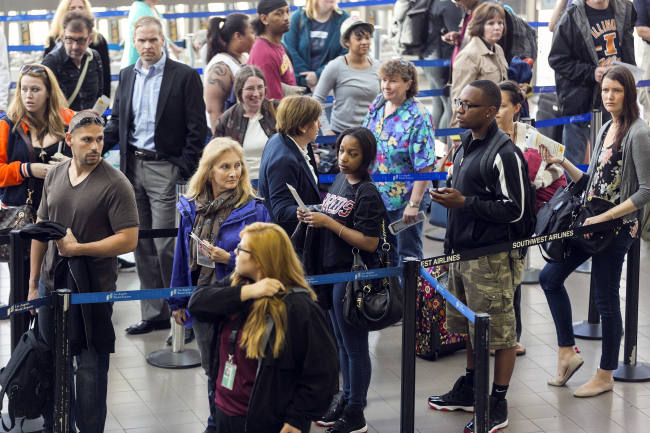 Travelers stand in line at Los Angeles International airport on Monday. (AP-Yonhap News)