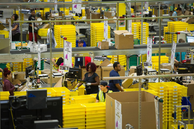 Employees pack items to be shipped from the Amazon.com Inc. distribution center in Phoenix, Arizona. (Bloomberg)