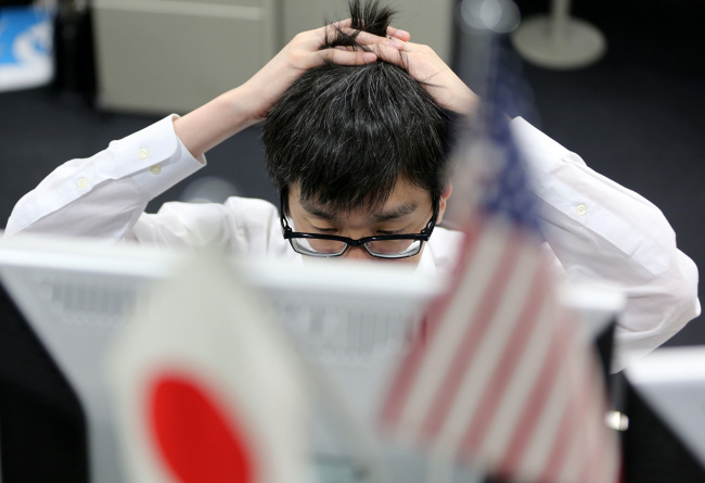 A dealer works at a foreign exchange brokerage in Tokyo on Monday. (Bloomberg)