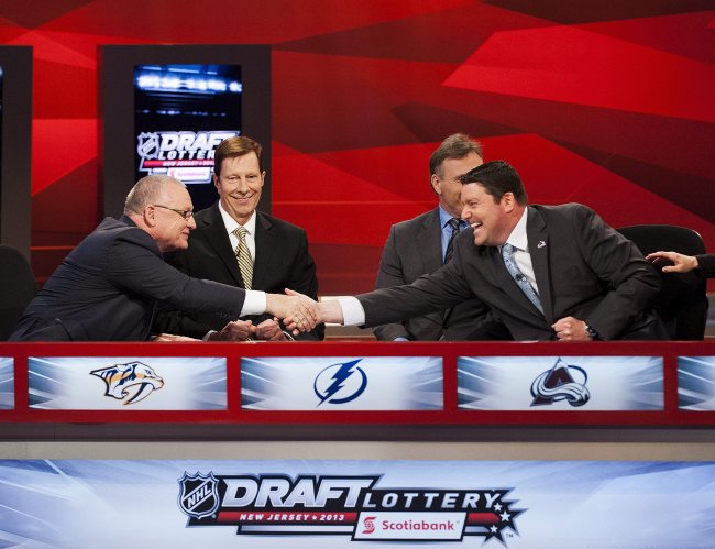 Rick Pracey (right), director of amateur scouting of the Colorado Avalanche, shakes hands with Jim Rutherford, general manager and president of the Carolina Hurricanes, alongside David Poile (second left), general manager of the Nashville Predators, and Pat Verbeek, assistant general manager of the Tampa Bay Lightning, after winning No. 1 in the NHL hockey draft lottery in Toronto on Monday. (AP-Yonhap News)