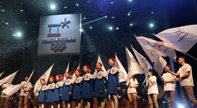 Children take part in a ceremony to unveil the emblem of the PyeongChang Winter Olympic Games at the National Gugak Center in Seoul on Friday. (Yonhap News)