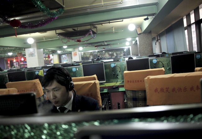A man uses computers at an Internet cafe in Shanghai. (Bloomberg)