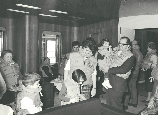 This 1965 photo provided by Anne D’Innocenzio shows her in the arms of her father, with her mother, sister and brother on a ship heading home from a family sojourn in Italy. (AP-Yonhap News)