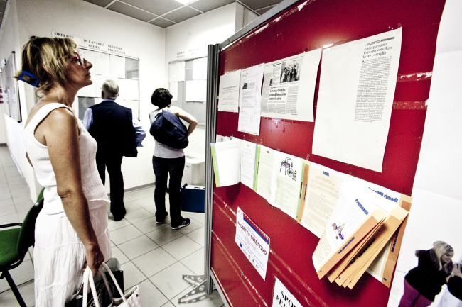 A jobseeker looks through job listings at an unemployment office in Rome. ( Bloomberg)