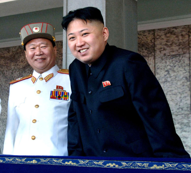 North Korean leader Kim Jong-un (right) and General Political Bureau Director Choe Ryong-hae watch a mass military parade together in Kim Il-sung Square in Pyongyang on April 15, 2012. (Yonhap News)