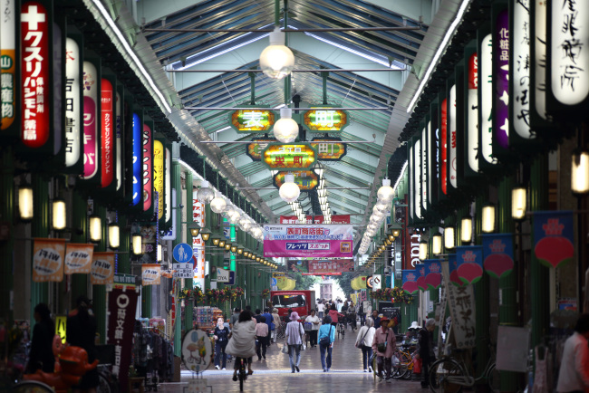 Pedestrians walk through a shopping street in Okayama, Japan. (Bloomberg)