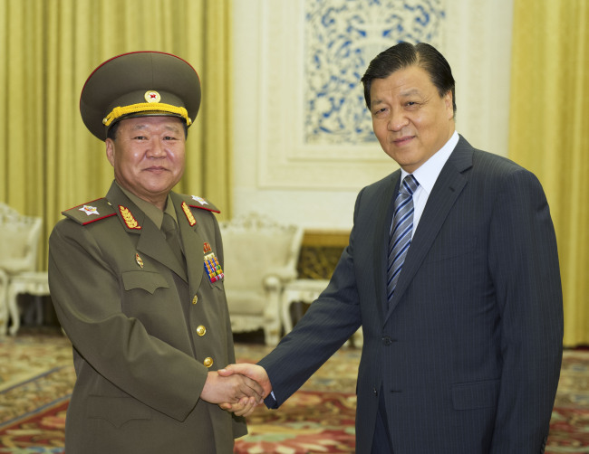 Liu Yunshan (right), a member of the Standing Committee of the Political Bureau of the Communist Party of China (CPC) Central Committee, meets with Choe Ryong-hae (left), the special envoy to the leader of the Democratic People`s Republic of Korea Kim Jong-un, in Beijing. (Xinhua-Yonhap News)