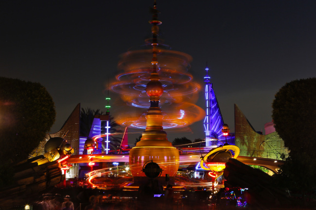 Guests walk through the Tomorrowland area of Walt Disney Co.`s California Adventure Park, part of the Disneyland Resort, in Anaheim, California on Friday. (Bloomberg-Yonhap News)