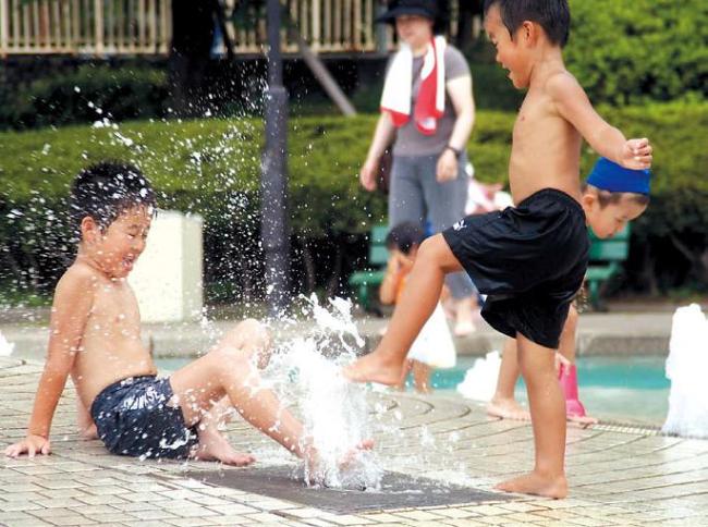 Children play at a water park in Tokyo. (Bloomberg)