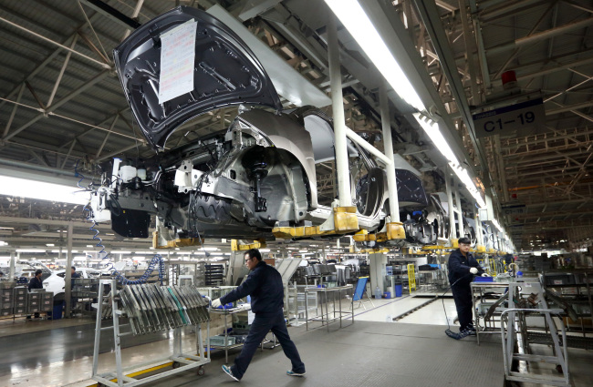 Workers assemble Beijing Hyundai Motor Co. cars on the production line at the company’s plant in Beijing. (Bloomberg)