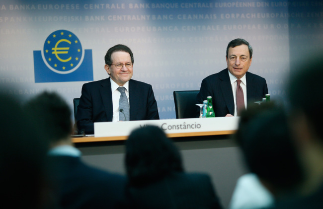 Vitor Constancio (left), vice president of the European Central Bank, reacts while Mario Draghi, president of the European Central Bank, speaks during a news conference at the bank’s headquarters in Frankfurt on Thursday. (Bloomberg)