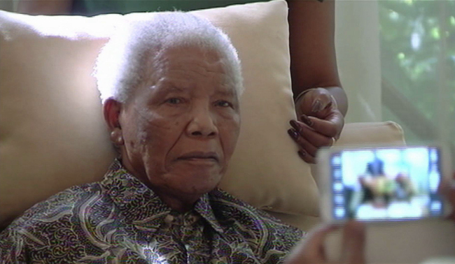 In this file image taken from video, the ailing anti-apartheid icon Nelson Madela is filmed Monday April 29, 2013, more than three weeks after being released from hospital. (AP-Yonhap News)