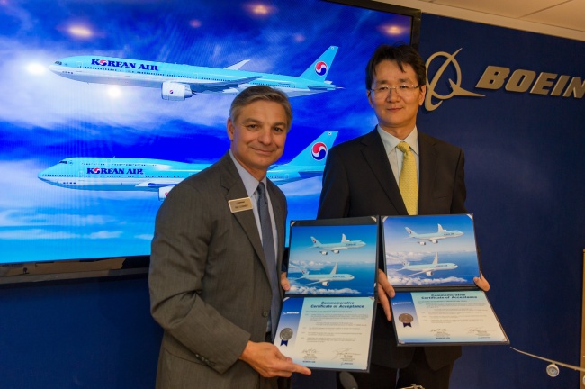 Korean Air executive vice president Cho Won-tae (right) and Boeing Commercial Airplanes president and CEO Ray Conner pose after the Korean air carrier agreed to purchase 11 next-generation aircraft from the U.S. company at the Paris Air Show on Tuesday. (Korean Air)