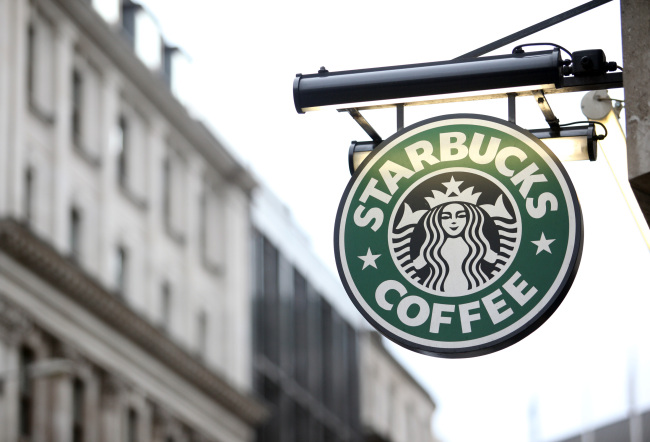 A Starbucks Corp. sign is displayed outside a coffee shop in London. Bloomberg