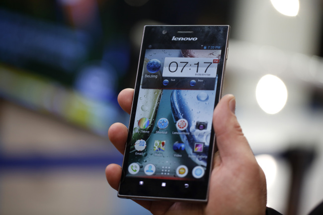 An employee displays a Lenovo K900 smartphone at the Mobile World Congress in Barcelona. (Bloomberg)