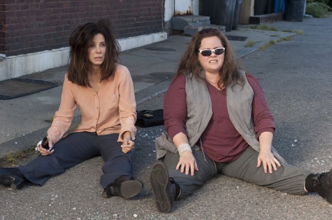 FBI Special Agent Sarah Ashburn (Sandra Bullock), left, and Boston Detective Shannon Mullins (Melissa McCarthy) sit in shock after an unexpected setback in “the Heat.” (MCT)