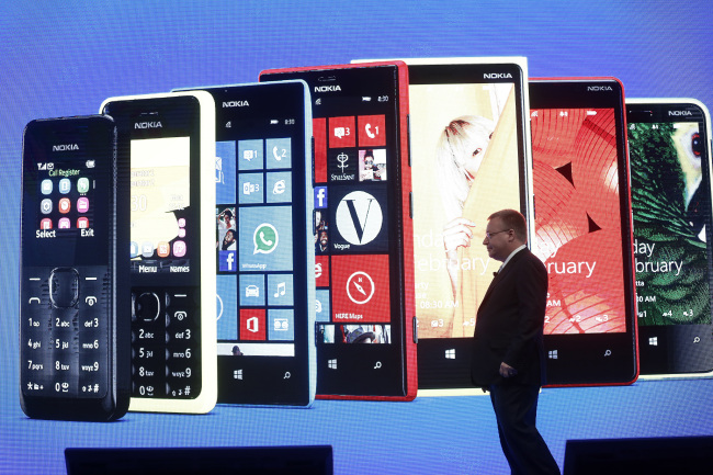 Stephen Elop, CEO of Nokia Oyj, stands in front of a projection screen of the latest Nokia range of smartphones during a news conference at the Mobile World Congress in Barcelona on Feb. 25. (Bloomberg)