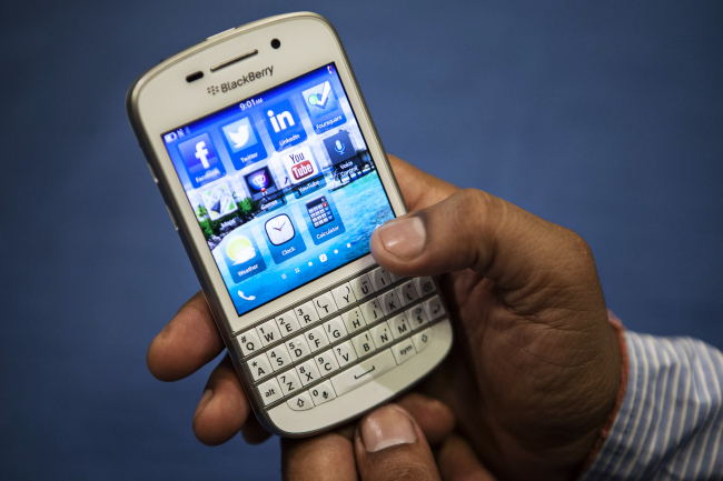 A BlackBerry India employee uses a BlackBerry Q10 smartphone after a news conference for the product’s India launch in New Delhi on June 6. (Bloomberg)