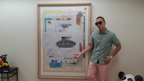 Naul poses in front of his art work at the opening of his art exhibition in Osaka, Japan, Thursday. (Naul)