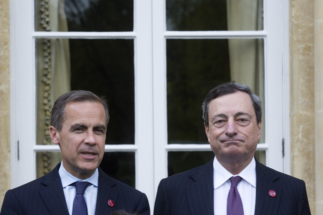 Mario Draghi (right), president of the European Central Bank, and Mark Carney, governor of Bank of England, pose during the Group of Seven finance ministers and central bank governors meeting at Hartwell House in Aylesbury on May 10. (Bloomberg)