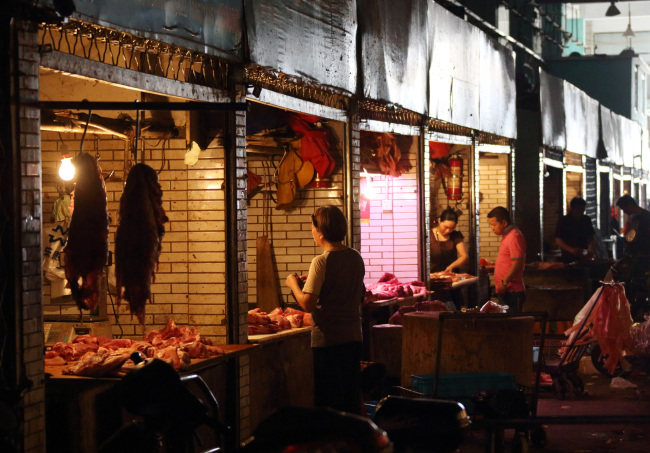 Customers shop for cuts of pork at a wholesale market in Shanghai. (Bloomberg)