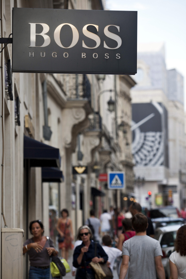 Shoppers pass the Hugo Boss AG store in Paris. (Bloomberg)