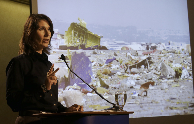 National Transportation Safety Board (NTSB) Chairwoman Deborah Hersman stands next to an image of the wreckage of Asiana Airlines flight 214 during a news conference on July 11. (AP-Yonhap News)