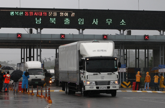 Members of the media film vehicles returning from the Gaeseong Industrial Complex as they pass a gate at the Customs, Immigration and Quarantine (CIQ) office near the demilitarized zone (DMZ) in Paju, South Korea, on Friday. (Bloomberg) 