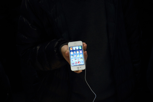 A customer tries an iPhone 5 at Apple’s store Beijing. (Bloomberg)