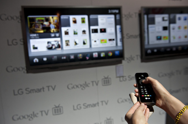 A product demonstrator uses a remote control to navigate a menu on an LG Smart TV with Google TV at the 2012 International Consumer Electronics Show in Las Vegas, Nevada. ( Bloomberg)