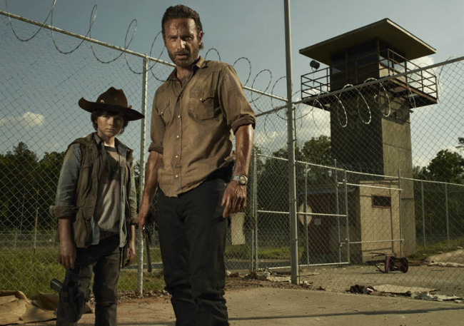 Actors Chandler Riggs (left) and Andrew Lincoln pose for a promotional shot for “The Walking Dead.” (AMC)