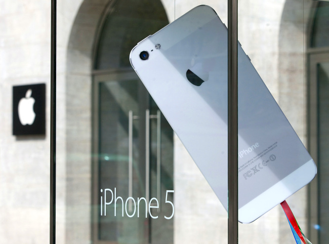 A mock oversized Apple Inc. iPhone 5 in a display case outside the Apple Inc. store in Berlin. (Bloomberg)