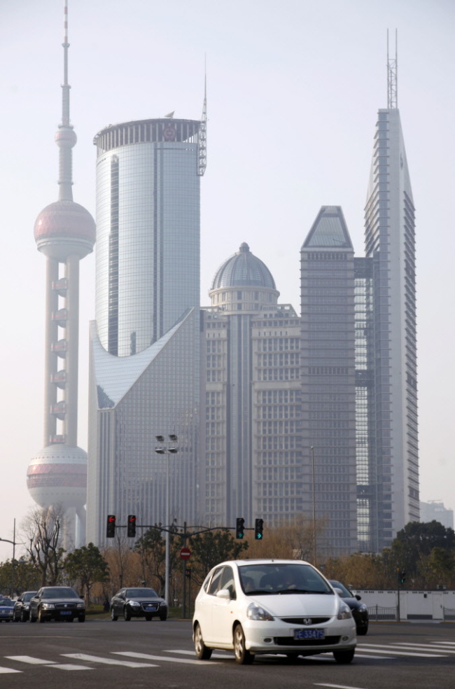 A vehicle travels through the Lujiazui Financial District in Shanghai. (Bloomberg)