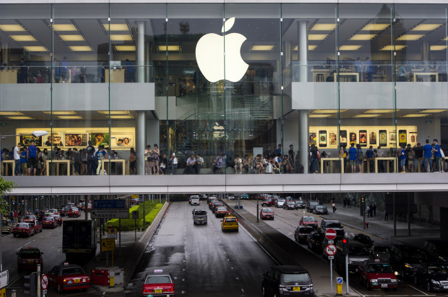 Customers shop at an Apple Inc. store in Hong Kong on July 16. ( Bloomberg)