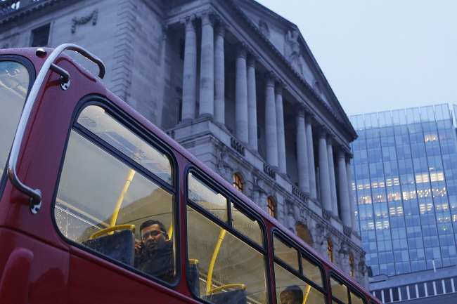 A passenger looks from the window of a London bus as it passes the Bank of England in London. (Bloomberg)