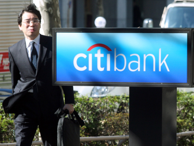 A businessman walks past a Citibank Japan Ltd. branch in Tokyo. (Bloomberg)