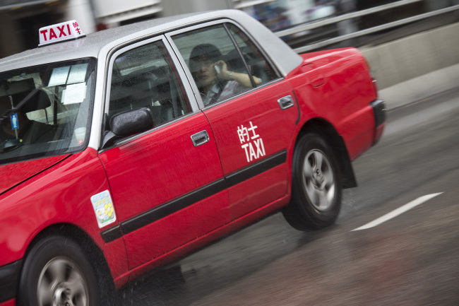 A taxi travels along a road in Hong Kong. ( Bloomberg)