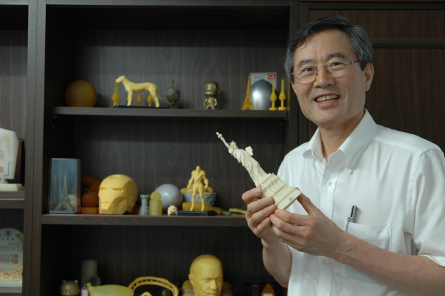 Carima CEO Lee Byung-keuk holds a miniature of Statue of Liberty manufactured by the company’s 3-D printer Master Plus. (Carima)