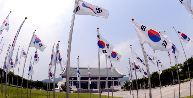 National flags stand in front of the main building of the Independence Hall in Mokcheon, South Chungcheong Province. Koreans celebrate their 68th Independence Day on Thursday, which also marks the establishment of the first modern republic in 1948. On the same day in 1953, The Korea Herald, then under the name of The Korean Republic, was created with a mission of bridging Korea and the world. Celebrating its 60th anniversary, The Korea Herald is committed to achieving its mission as the leading English-language newspaper in the country. (Ahn Hoon/The Korea Herald)