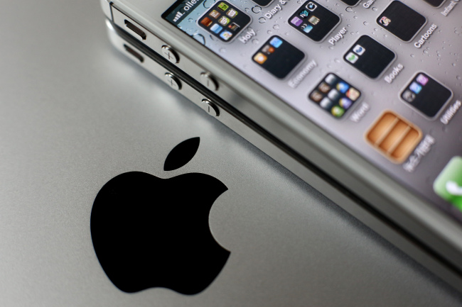 An Apple Inc. iPhone is arranged for a photograph next to the company’s logo in Seoul. (Bloomberg)