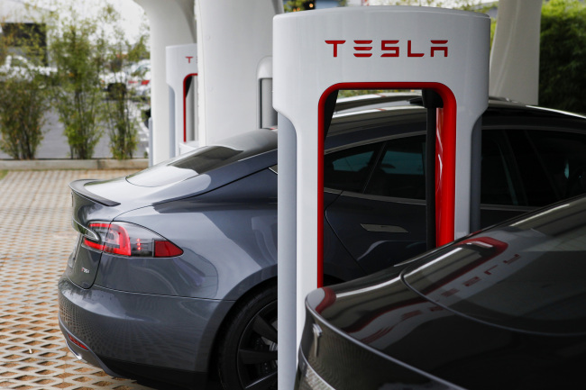 A Tesla Motors Inc. vehicle is charged at the company’s design studio in Hawthorne, California. (Bloomberg)