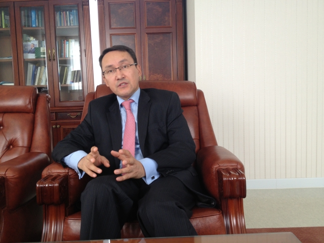 Kazakh Ambassador to South Korea Dulat Bakishev gestures during an interview with The Korea Herald at his office in Itaewon on Wednesday. (Philip Iglauer/The Korea Herald)