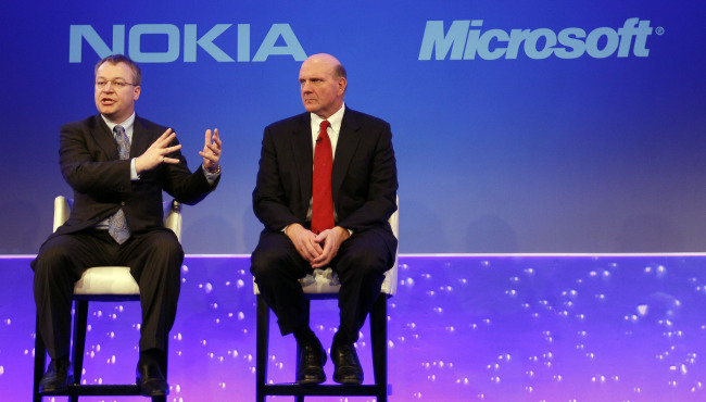 This Feb. 11, 2011 file photo shows Stephen Elop CEO of Nokia, left, with CEO of Microsoft Steve Ballmer, speaking in London. Microsoft says it is buying Nokia`s devices and services business, and getting access to the company`s patents, for a total of 5.44 billion euros ($7.2 billion) in an effort to expand its share of the smartphone market. (AP-Yonhap News)