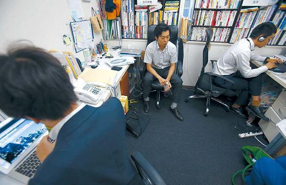 Terra Motors Corp. employee Shimpei Kato (center) speaks during an interview at company headquarters in Tokyo’s Shibuya district. (AP-Yonhap News)