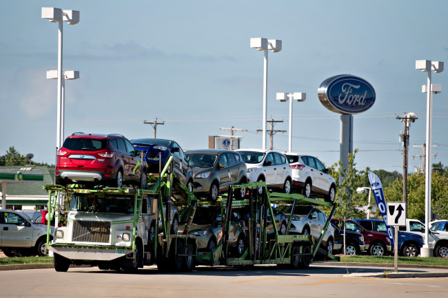 Ford Motor Co. Escape 2014 vehicles sit on a car carrier near the Bill Walsh Ford car dealership in Ottawa, Illinois. (Bloomberg)