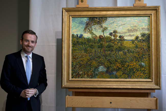 Van Gogh Museum director Axel Rueger (left), poses next to “Sunset at Montmajour” after unveiling the painting by Dutch painter Vincent Van Gogh during a press conference at the museum in Amsterdam, Netherlands, Monday. ( AP-Yonhap News)