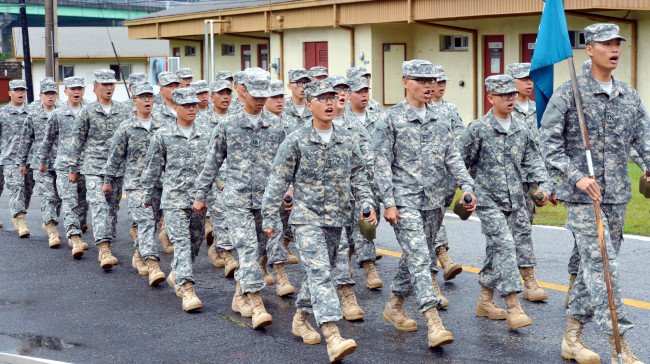 A group of new recruits march during a drill-and-ceremony training session at the KATUSA Training Academy in Camp Jackson in Uijeongbu, north of Seoul, last month.