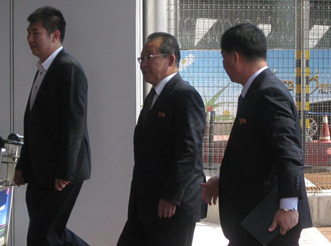 North Korea`s chief nuclear negotiator, Kim Kye-gwan, and his aides arrive at a Beijing airport to depart for Pyongyang on Friday after their five-day visit to the Chinese capital.(Yonhap News)