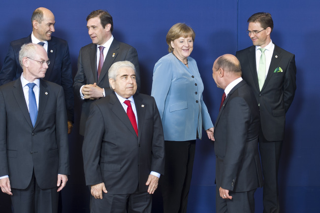 European Council President Herman Van Rompuy (left) and German Chancellor Angela Merkel (third from right) gather for a photograph during the European Leaders summit at the European Council headquarters in Brussels on May 23, 2012. (Bloomberg)