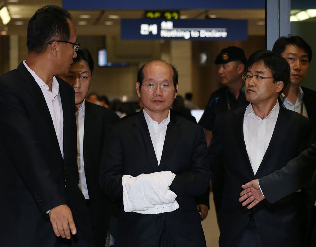 Former SK Shipping Co. advisor Kim Won-hong, a key figure in SK Group chairman Chey Tae-won’s slush fund case, arrives at Incheon International Airport after being extradited from Taiwan on Thursday. (Yonhap News)